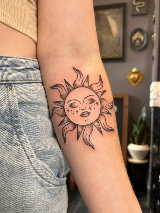 Medium Blackwork Sun with Face on Women Arm Tattoo by @tywalkertattoos