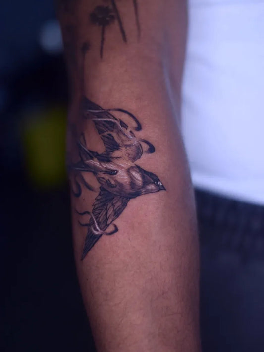 Medium Blackwork Swallow Tattoo on Men Arm by @tattooist_tinco