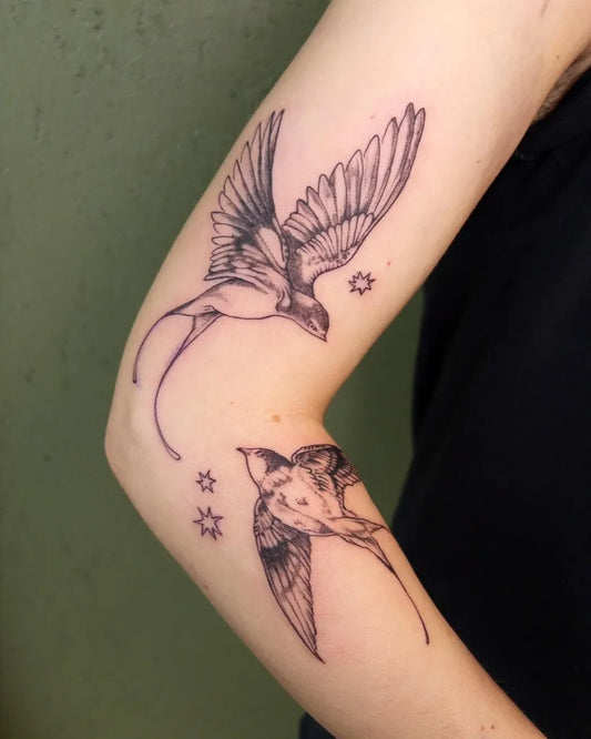 Medium Blackwork Swallow and Stars Tattoo on Women Arm by @ellunatattoo