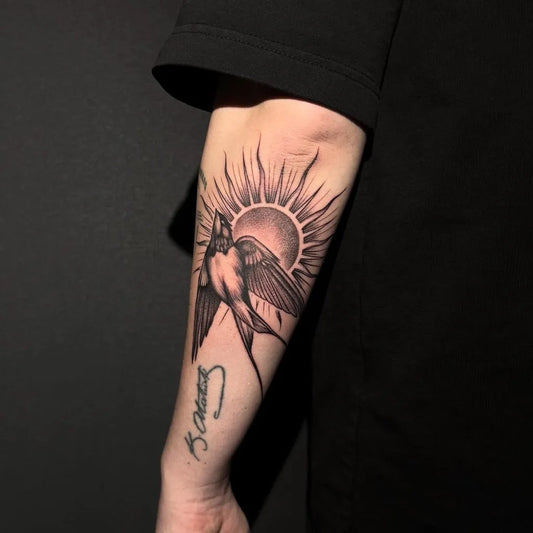 Medium Blackwork Swallow and Sun Tattoo on Men Arm by @prismatattoo