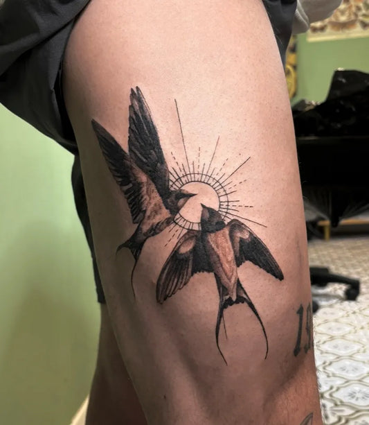 Medium Blackwork Swallow and Sun Tattoo on Men Thigh by @marnietattoos