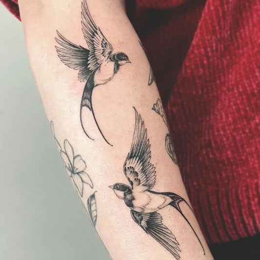 Medium Blackwork Swallows and Flowers Tattoo on Women Arm by @diflooo
