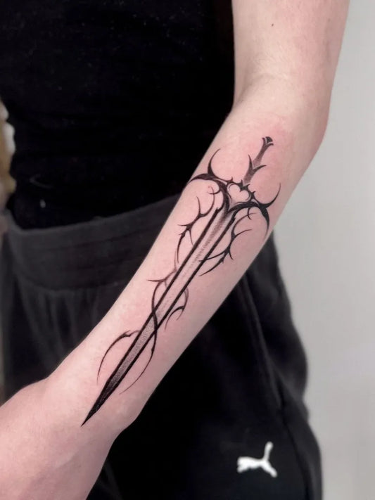 Medium Blackwork Sword on Women Arm Tattoo by @maugrimm.ink