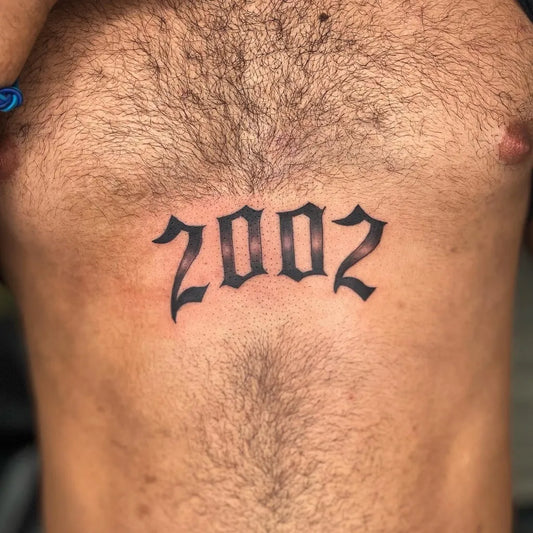 Medium Blackwork Text Number Tattoo on Men Chest by @cruz_tattoos2020