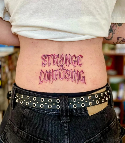 Medium Blackwork Text Tattoo on Women Lower Back by @amelieseipler