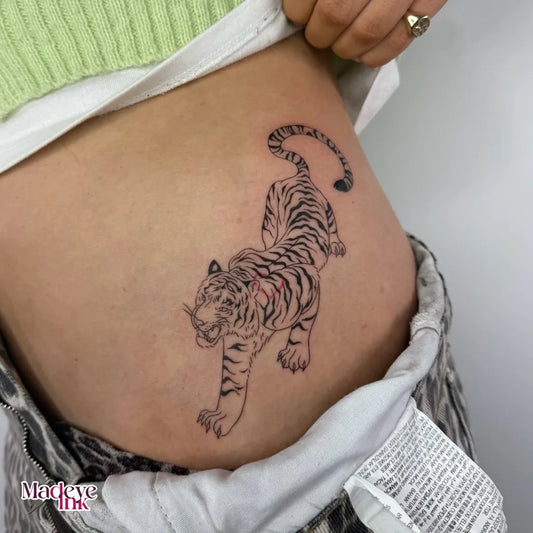 Medium Blackwork Tiger on Women Hip Tattoo by @madeye.ink