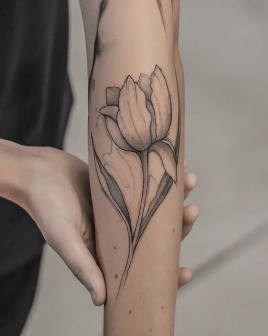Medium Blackwork Tulip Tattoo on Women Arm by @georgefrancis.art