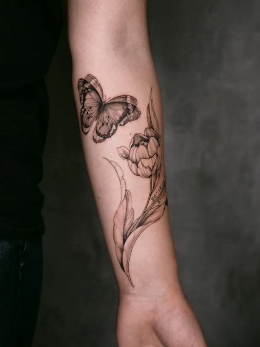 Medium Blackwork Tulip and Butterflies Tattoo on Women Arm by @tattooist.jev