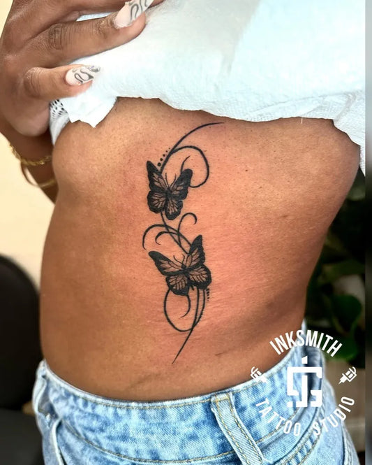 Medium Blackwork Two Butterflies on Women Side Tattoo by @inksmithtattoobda