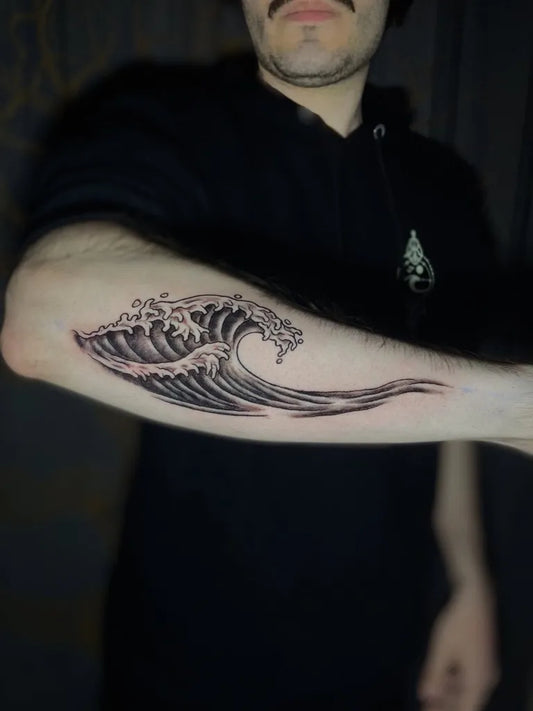 Medium Blackwork Wave Tattoo on Men Arm by @arvoretattoopraiadorosa