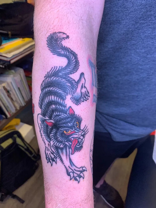 Medium Blackwork Wolf on Men Arm Tattoo by @mr.wrighttattoos