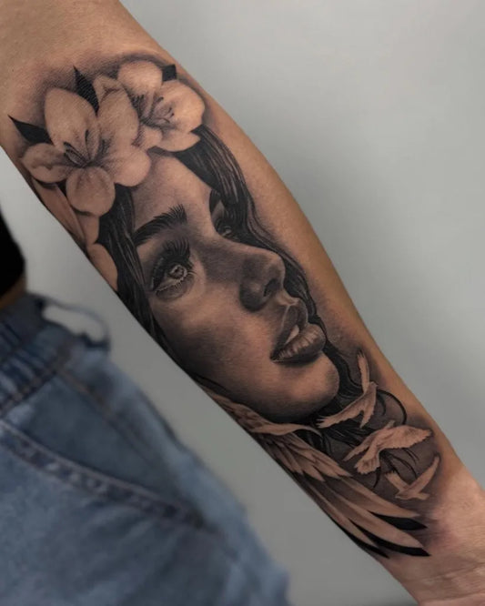 Medium Blackwork Woman with Lily and Feathers on Women Arm Tattoo by @dame.arte