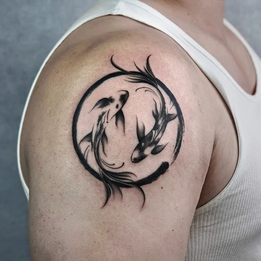 Medium Blackwork Yin Yang Koi Tattoo on Men Shoulder by @mako.tattoo_tokyo