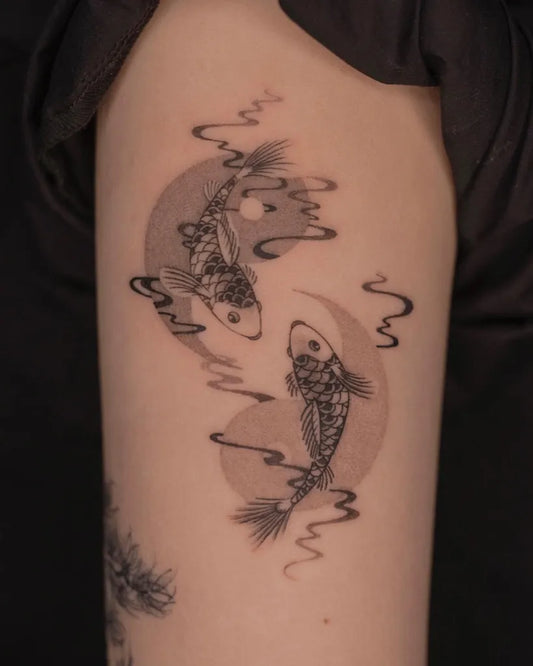 Medium Blackwork Yin Yang Koi Tattoo on Women Arm by @dahan.orient