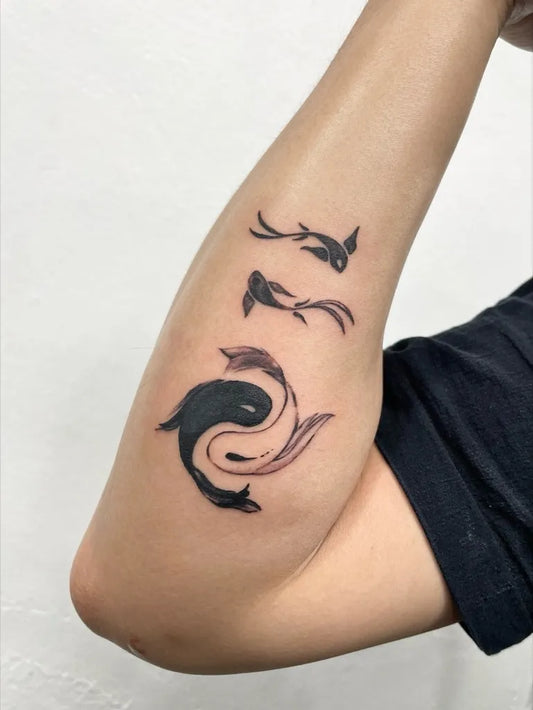 Medium Blackwork Yin Yang Koi Tattoo on Women Arm by @odstudiotattoo
