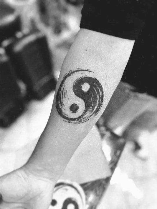 Medium Blackwork Yin Yang Tattoo on Women Arm by @cece.aleman