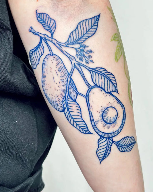 Medium Blue Avocado Branch Tattoo on Women Arm by @pelc.tt