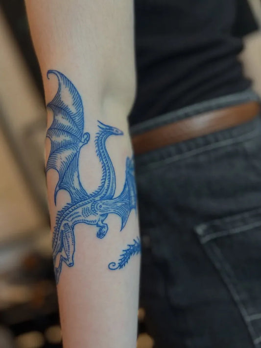 Medium Blue Dragon Tattoo on Women Arm by @vivian.tattoo