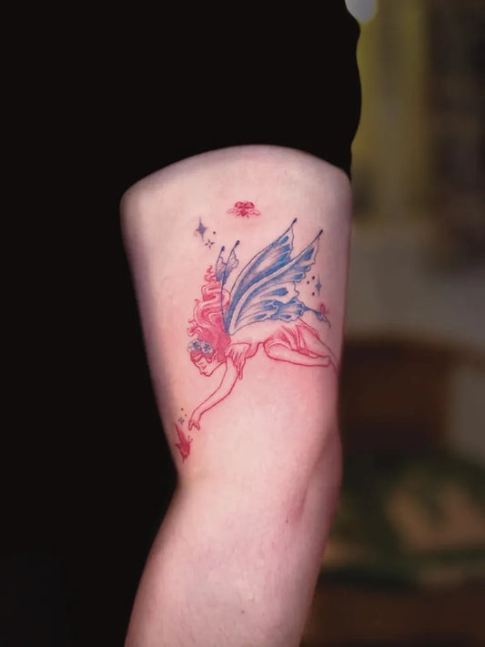 Medium Blue Fairy Tattoo on Women Arm by @nesi.ink