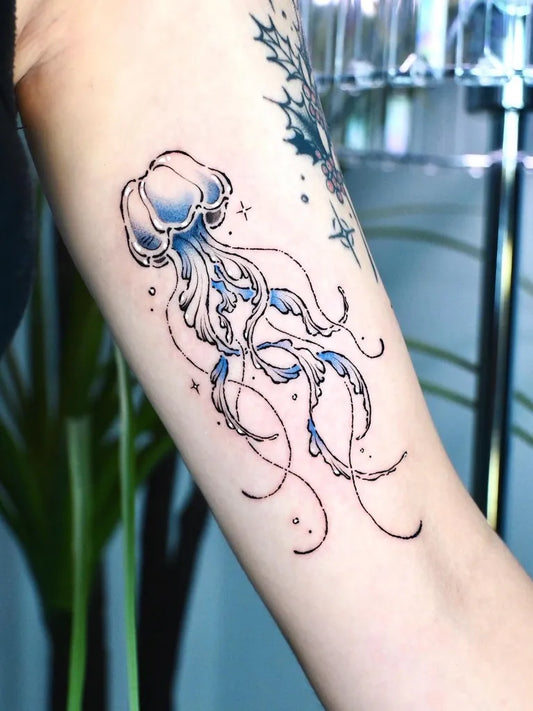 Medium Blue Jellyfish Tattoo on Women Arm by @viiu.tt