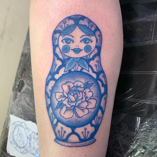 Medium Blue Matryoshka Doll Tattoo on Women Leg by @artsandwitchcrafts
