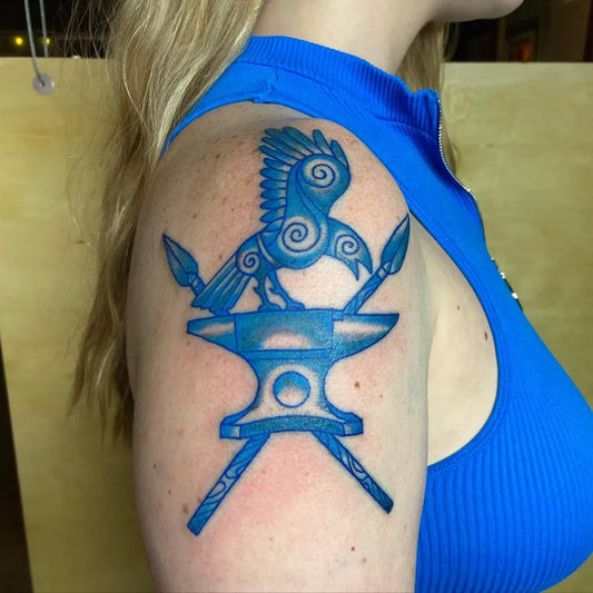 Medium Blue Raven Anvil Tattoo on Women Shoulder by @artworksbymatt