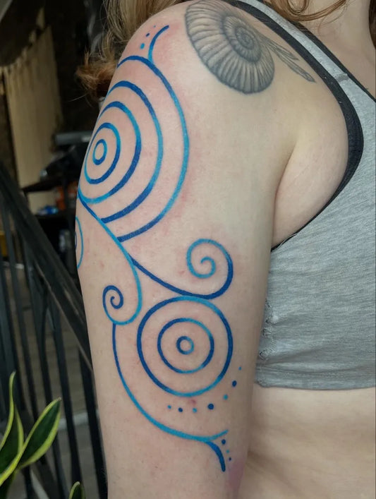 Medium Blue Spirals and Shell Tattoo on Women Arm by @changing_expression