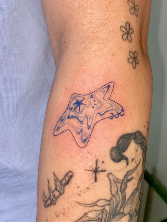 Medium Blue Starfish Tattoo on Women Arm by @xinyu.art