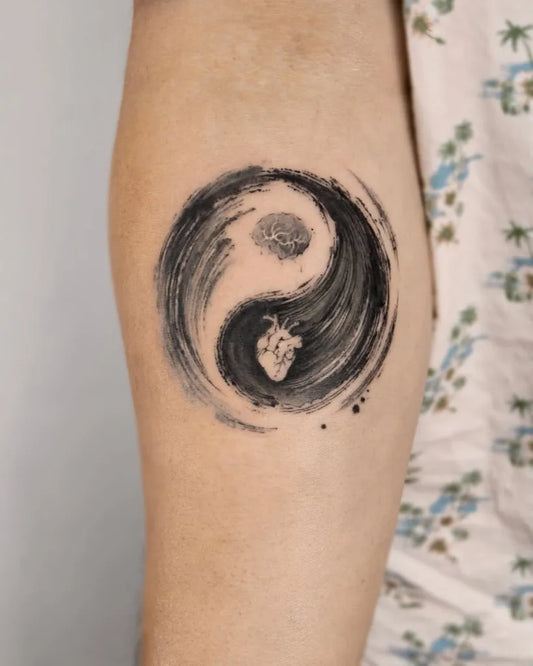Medium Brush Stroke Yin Yang Heart Tattoo on Women Arm by @baronarttattoo