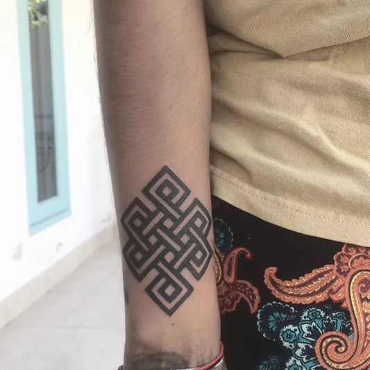 Medium Celtic Endless Knot Tattoo on Women Arm by @vins_ink