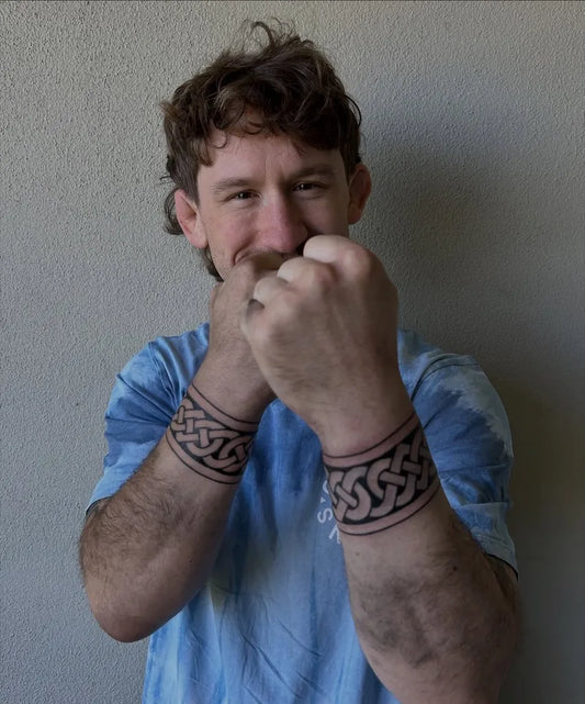 Medium Celtic Knot Band Tattoo on Men Forearms by @celtictattooer