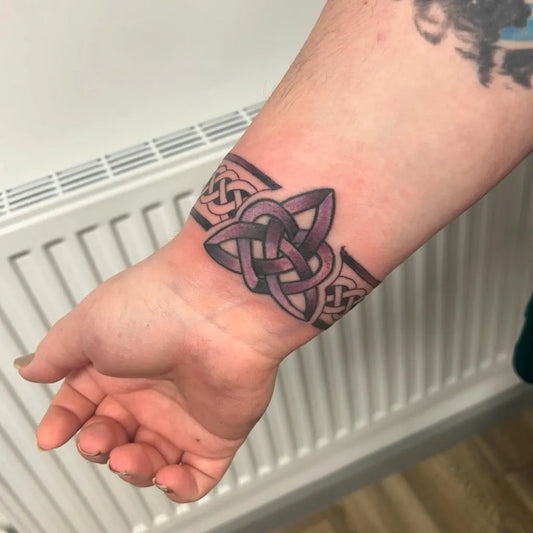 Medium Celtic Knot Band Tattoo on Men Wrist by @tashas.art