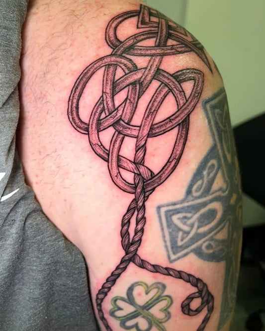 Medium Celtic Knot with Shamrock Tattoo on Men Shoulder by @gamble.tattoos