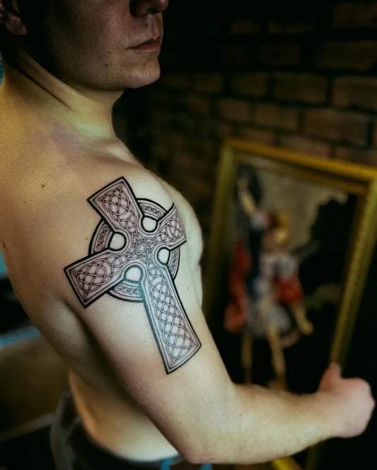 Medium Celtic Knotwork Cross Tattoo on Men Shoulder by @leo_potter_tattoo