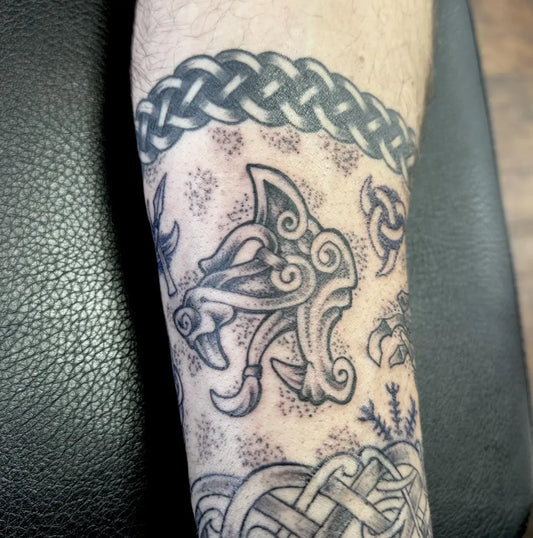 Medium Celtic Wolf Head and Knotwork Tattoo on Men Arm by @manxtattoo
