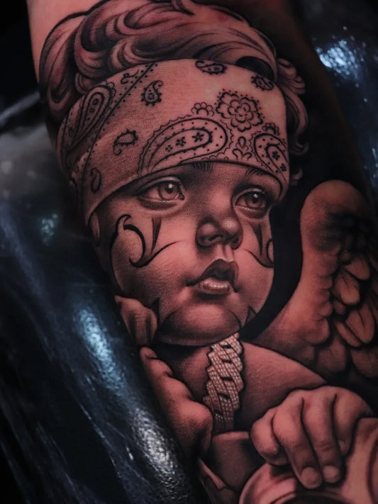 Medium Chicano Chicano Baby Angel Tattoo on Men Arm by @bigjantattooer