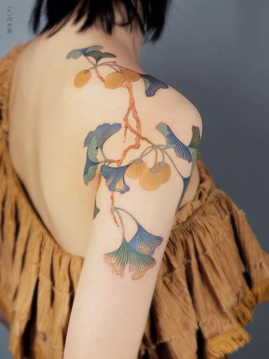 Medium Chinese Ginkgo Branches and Fruit Tattoo on Women Shoulder by @tattoo.vinc