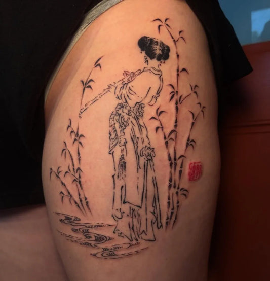 Medium Chinese Woman Playing Flute with Bamboo Tattoo on Women Thigh by @xpg.ink
