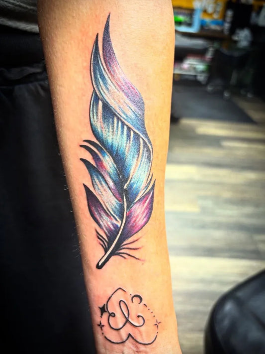Medium Color Realism Feather Heart Stars Tattoo on Women Arm by @stevemcalistertattoos
