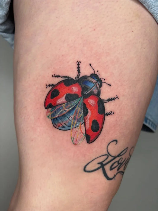 Medium Color Realism Ladybug Tattoo on Women Thigh by @crucibletattooco