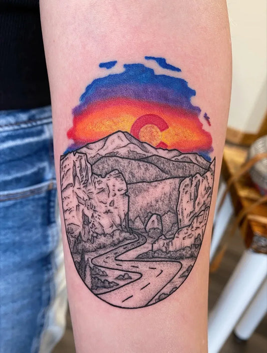 Medium Color Woodcut Mountain Sunset Road Tattoo on Women Arm by @driftwoodtattoostudio