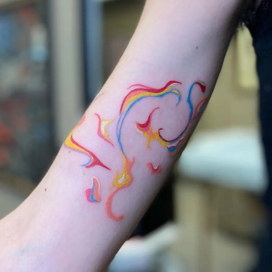 Medium Colorful Abstract Flames Tattoo on Women Arm by @threetidestattoobooking