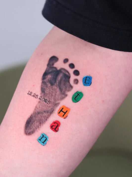 Medium Colorful Baby Footprint with Name Letters Tattoo on Men Arm by @tattoosbyanva
