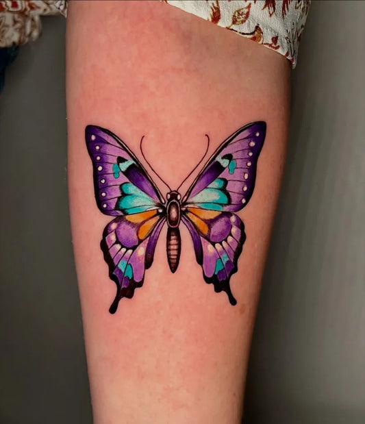 Colorful Butterfly on Women Arm Tattoo by @joibaileytattoos