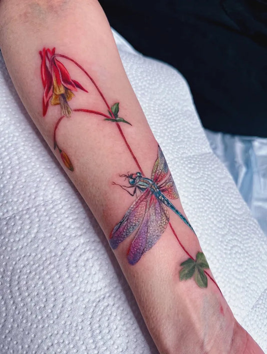 Medium Colorful Fuchsia Flower and Dragonfly Tattoo on Women Arm by @emeline.rosetattoos
