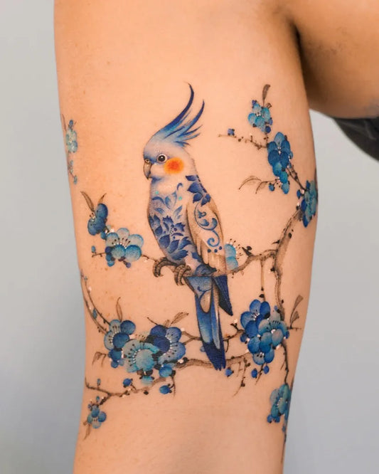 Medium Delicate Blue Cockatiel and Blossoms Tattoo on Women Arm by @e.nal.tattoo