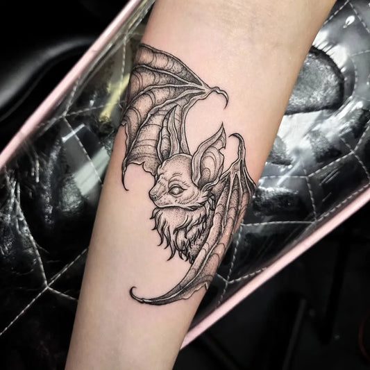 Medium Dotwork Bat Tattoo on Women Arm by @izzyxtattoos
