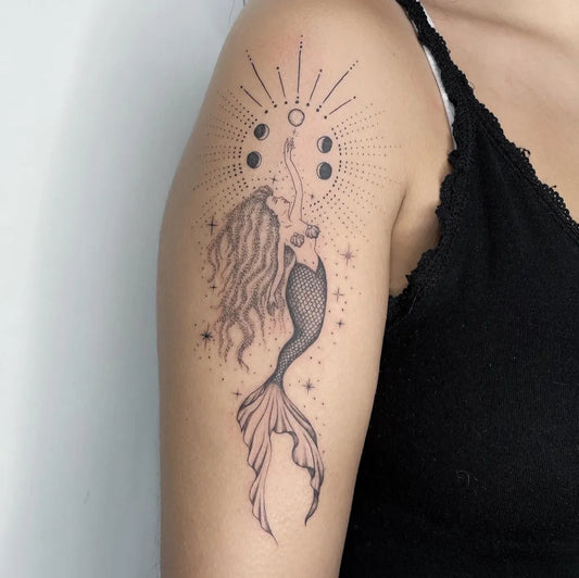 Medium Dotwork Moon Phases Mermaid Tattoo on Women Shoulder by @nauanatattoos