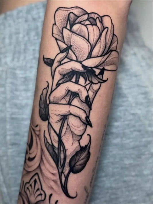 Medium Dotwork Rose Held By Hand Flower Tattoo on Women Forearm