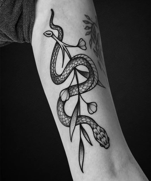 Medium Dotwork Snake with Flowers and Leaves Tattoo on Women Arm by @cedstamantattoo